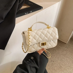 White quilted leather shoulder bag with gold chain strap and elegant gold twist lock