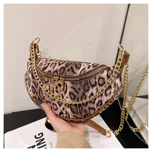 Detailed shot of leopard print handbag with chunky gold chain and ring zipper closure