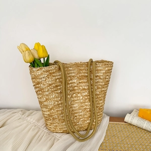 Handwoven straw bucket bag with rope handles for summer vacation and beach outfits
