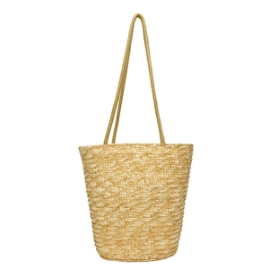 Handmade woven straw bucket bag for summer beach holidays with natural fiber texture