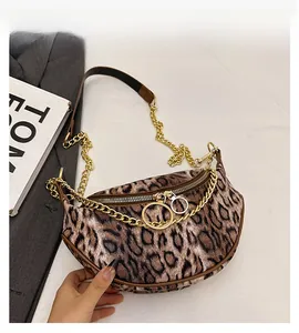 Detail view of leopard print crescent bag with gold chain and double ring zipper pullers