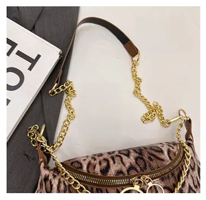 Detailed close-up of leopard print shoulder bag with chain strap and dual metal zippers