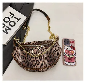 Top view of leopard print crescent bag with gold chain strap and dual zipper detail