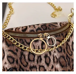 Close-up of leopard print shoulder bag featuring smooth gold ring zippers and metal chain