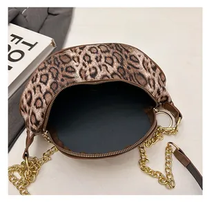 Interior view of leopard print crossbody bag with golden chain and zip closure