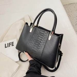 Black crocodile embossed tote bag with gold hardware and removable shoulder strap