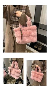 Close-up of pink faux fur tote bag showing plush striped texture and woven cord pendant
