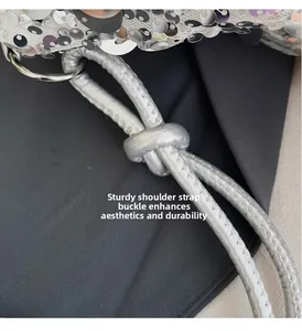Detailed macro view of the silver sequin bag featuring a sturdy knotted metal strap buckle
