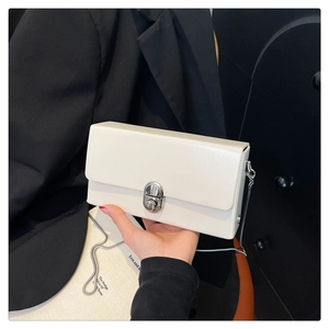 Close-up of the vintage silver clasp and premium cream leather on the chain bag