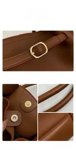 Close-up of brown textured leather tote showing gold buckle, magnetic clasp, and stitching