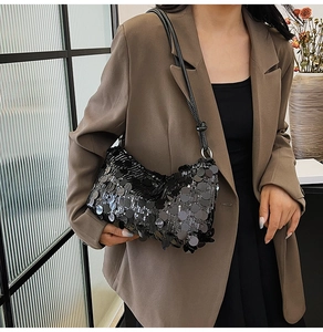 Detail of black sequins on a rectangular shoulder bag with a knotted leather strap