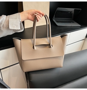 Detailed view of large khaki tote bag with premium lychee grain leather texture