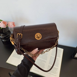 Retro brown croc-embossed underarm bag with gold chain and circular turn-lock closure