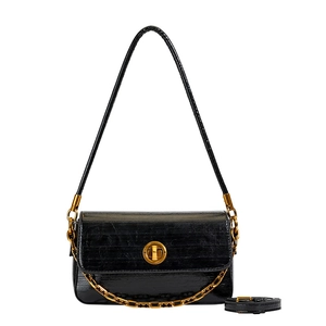 Chic black crocodile embossed shoulder bag with gold chain and circular swivel lock