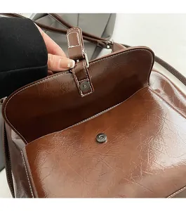 Gros plan détaillé du fermoir magnétique sur un sac à dos en cuir texturé vintage