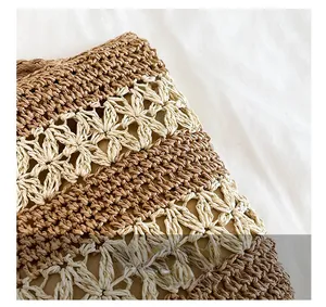Gros plan d'un sac en paille tissé à la main avec rayures et motifs de crochet floraux