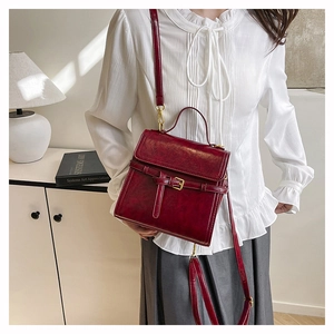 Detailed view of the dark red retro crossbody bag with premium glossy PU leather texture