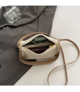 Top view of spacious interior with inner pocket in cream pleated bucket bag