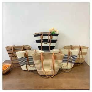 Detailed arrangement of striped straw tote bags with leather handles in various colors