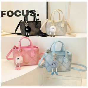 Detail of four colorful mini bucket bags with quilted patterns and plush monster charms
