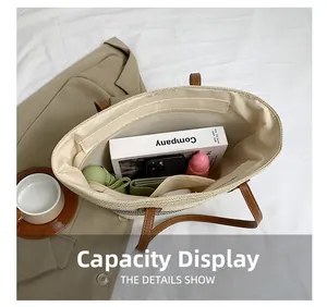 Straw tote interior showing large capacity with pockets and premium leather handles