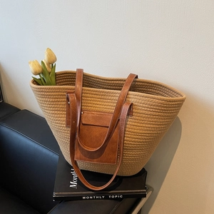 Summer woven straw tote bag with brown leather straps and front pocket detail