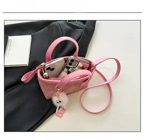 Internal capacity of pink quilted bucket bag showing space for phone and lipstick