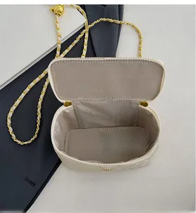 Top view of cream quilted bag showing interior space with chain strap and lining