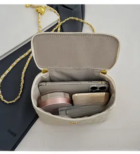 Internal layout of quilted chain bag showing space for phone, perfume and powder compact