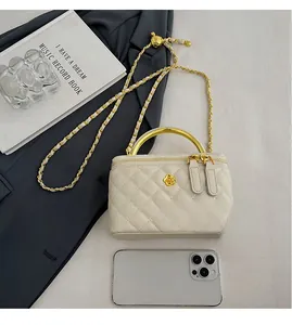 Detailed comparison showing white quilted bucket bag size against a mobile phone