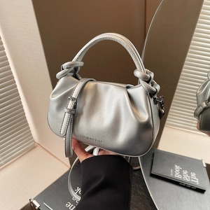 Silver metallic pleated handbag with adjustable shoulder strap and top handle design