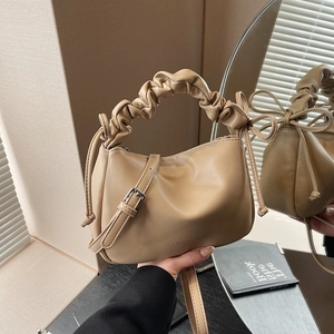 Beige soft leather crossbody bag with pleated handle and side decorative bows