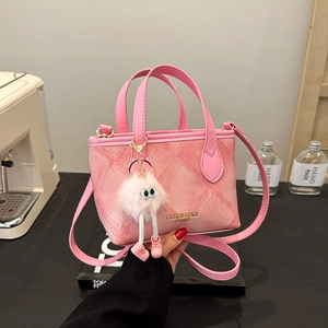 Pink denim texture mini bucket bag with leather trim and plush monster charm