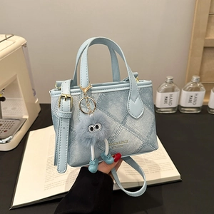 Minimalist light blue bucket bag with denim texture print and cute plush ball charm