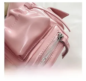 Macro detail of the front pocket on a pink oil wax leather shoulder bag with silver zipper