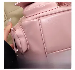 Detailed close-up showing high-quality stitching on a pink vintage motorcycle shoulder bag
