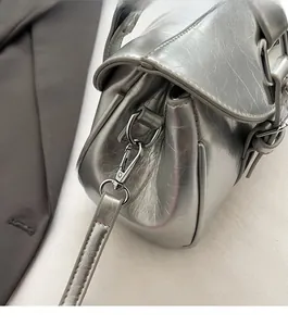 Macro detail of high-quality silver metallic hardware and textured leather on retro handbag
