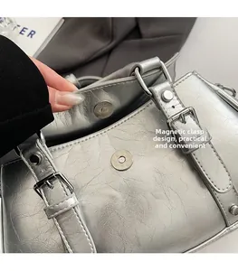 Silver leather handbag detail showing the practical magnetic snap closure design