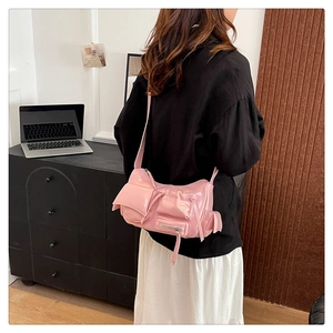 Detailed view of pink oil-wax leather motorcycle bag with Y2K style pockets and zippers