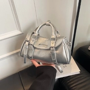 Close-up of a vintage silver metallic handbag with adjustable buckle and top handles