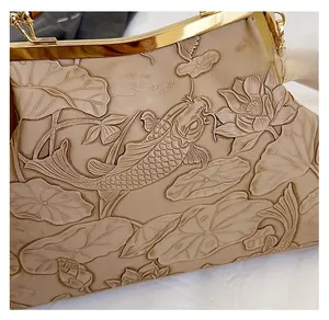 Detail of vintage evening bag with koi and lotus embossing on premium beige leather