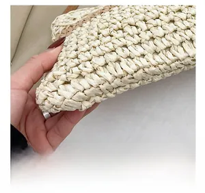 Detailed view of precision stitching and natural woven texture on summer straw bag
