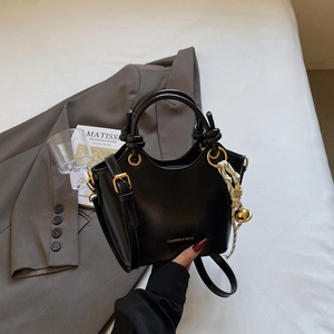 Chic black leather tote bag with knot handles and adjustable strap for women
