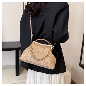 Detail of vintage beige shoulder bag with lotus embossing and chunky gold chain strap