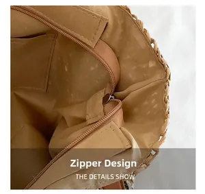 Detail view of straw bag interior featuring a zip closure and premium fabric lining