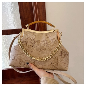Detailed relief of koi fish and lotus on vintage beige clutch bag with golden frame