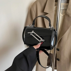 Sac à main en cuir verni noir avec boucle épingle argentée et bandoulière tendance