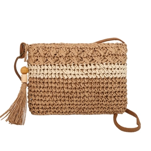 Large straw shoulder bag with woven fringes and wooden beads for summer beach vacations