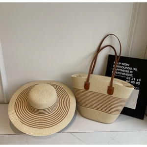 Matching straw beach set with striped woven tote bag and wide-brimmed sun hat