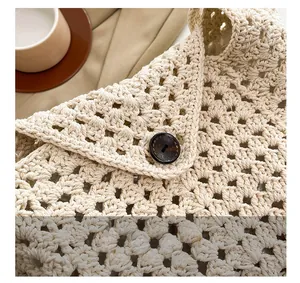 Detailed close-up of retro wooden button closure on cream woven tote bag
